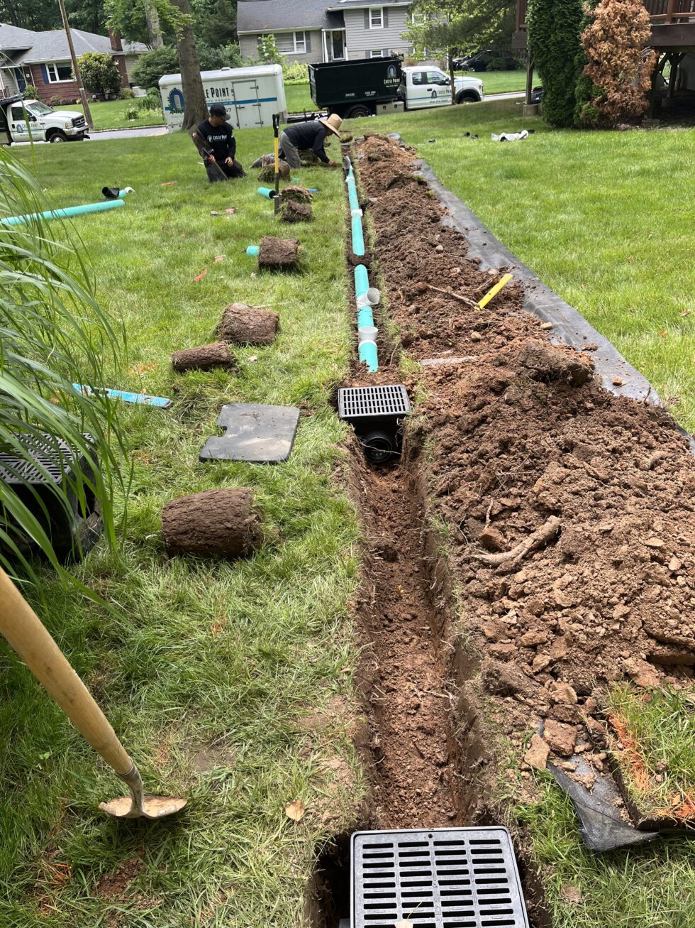 Residential drainage and grading system installation to manage stormwater and prevent soil erosion around property.